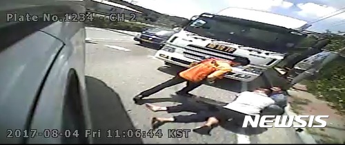 【안성=뉴시스】 장태영기자 = 4일 오전 10시50분께 경기 안성시 미양면 양변리 인근 편도 1차로에서 신호대기 중이던 화물차 운전자 한모(59)씨가 의식을 잃어 뒤따르던 이모(52)씨의 화물차를 들이 받았다. 이씨는 한씨를 발견하고 심폐소생술을 시도했고, 출동한 소방대원의 응급처치로 한씨는 의식을 회복했다. 사진은 이씨가 한씨에게 심폐소생술을 시도하는 모습. 2017.08.04. (사진=안성소방서 제공) photo@newsis.com
