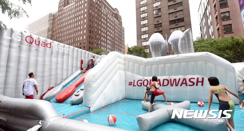 【서울=뉴시스】5일(현지시각) 미국 뉴욕 맨하탄 거리에서 열린 '시티 서머 스트리트' 행사에서 LG전자 쿼드워시 식기세척기를 본 딴 'LG 쿼드워시 워터파크'에서 고객들이 물놀이를 즐기고 있다. 2017.08.06.(사진=LG전자 제공) photo@newsis.com