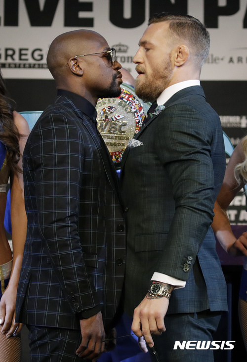 Floyd Mayweather Jr., left, and Conor McGregor pose for photographers during a news conference Wednesday, Aug. 23, 2017, in Las Vegas. The two are scheduled to fight in a boxing match Saturday in Las Vegas. (AP Photo/John Locher)