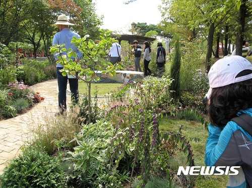 【안산=뉴시스】이종일 기자 = 제5회 경기정원문화박람회가 29일 안산시 화랑유원지에서 열린 가운데 한 시민이 소규모 정원에서 사진촬영을 하고 있다. 2017.09.29.    lji22356@newsis.com