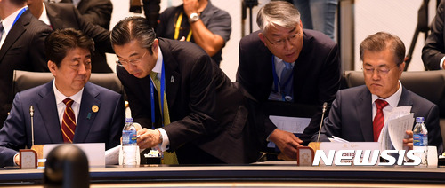 【다낭(베트남)=뉴시스】전진환 기자 = 문재인 대통령이 11일 오전(현지시각) 아시아태평양경제협력체(APEC) 정상회의가 열린 베트남 다낭 인터콘티넨탈호텔 회의장에서 회의 자료를 살피고 있다. 왼쪽은 아베 신조 일본 총리. 2017.11.11. amin2@newsis.com