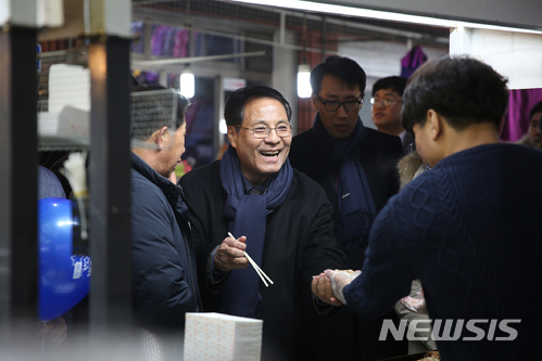 【대전=뉴시스】 한남대 이덕훈 총장이 중리달빛야시장을 찾아 한남대 학생들이 창업한 점포에서 음식을 먹고 있다.(사진=한남대 제공) 