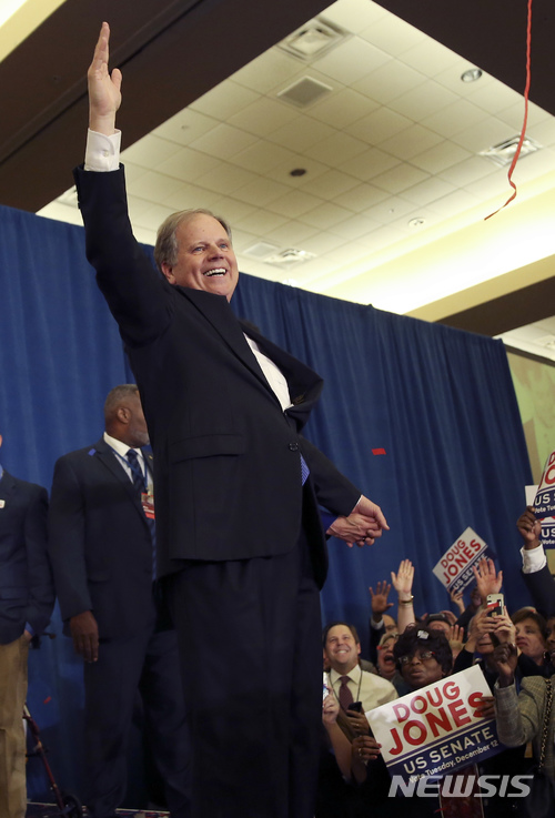 【버밍엄=AP/뉴시스】 더그 존스 미국 민주당 후보가 12일(현지시간)앨라배마주 버밍엄에서 공화당의 로이 무어 후보를 근소한 차로 제치고 연방상원의원에 당선된 후 지지자들을 향해 손을 흔들어 보이고 있다. 2017.12.13