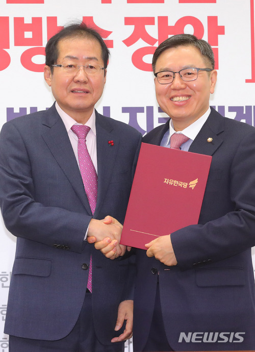 【서울=뉴시스】배훈식 기자 = 28일 오전 서울 여의도 자유한국당 당사에서 열린 최고위원 및 주요당직자 임명장 수여식에 참석한 홍준표(왼쪽) 대표가 정태옥 대변인과 기념촬영을 하고 있다. 2017.12.28. dahora83@newsis.com