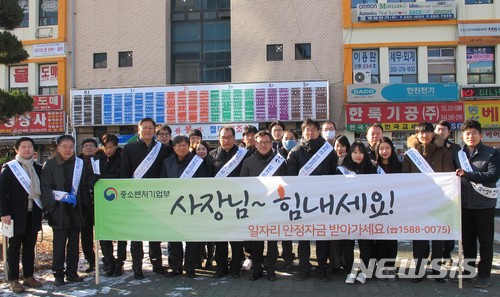 【창원=뉴시스】 홍정명 기자 = 11일 경남 창원시 창원기계공구상가 앞에서 경남지방중소벤처기업청, 중소기업중앙회 경남본부, 중진공 경남본부 등 6개 중소기업 지원기관 임직원 30여명이 '일자리 안정자금 현장홍보' 캠페인에 앞서 기념촬영을 하고 있다.2018.01.11.(사진=경남지방중소벤처기업청 제공) photo@newsis.com