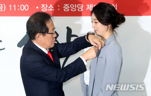 【서울=뉴시스】박영태 기자 = 9일 오전 서울 영등포구 여의도 자유한국당 당사에서 열린 자유한국당 영입인사 환영식에서 홍준표 대표가 배현진 전 아나운서에게 자유한국당 태극기 배지를 달아주고 있다. 2018.03.09.since1999@newsis.com