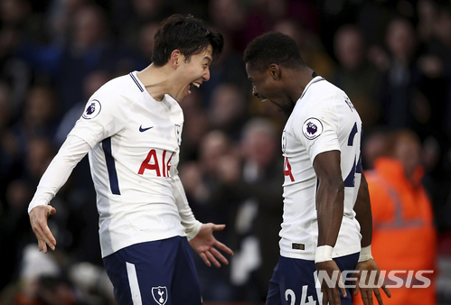Tottenham Hotspur's Serge Aurier, right, celebrates scoring his side's fourth goal against AFC Bournemouth with teammate Son Heung-Min, during their English Premier League soccer match at the Vitality Stadium in Bournemouth, Sunday March 11, 2018. (John Walton/PA via AP)