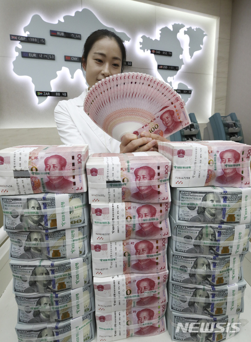 【서울=뉴시스】최진석 기자 = 중국이 위안화 표시 원유 선물 거래를 시작한 26일 오전 서울 중구 KEB하나은행에서 관계자들이 위안화와 달러를 정리하고 있다. 중국 선물시장으로선 처음으로 외국인도 거래에 참여할 수 있도록 했다. 원유 선물거래 시도는 중국 시장 국제화를 진전시킬 수 있는 기회가 될 수 있을 것으로 예상된다. 위안화 표시 원유 선물거래 상장은 달러가 미국의 서부 텍사스산 원유(WTI)와 유럽의 북해산 브렌트유가 국제 원유선물 지표가 되고 있는 현상에 대항하겠다는 의도가 있는 것으로 보인다. 2018.03.26. myjs@newsis.com