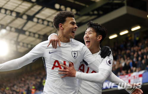 Tottenham's Dele Alli celebrates with Son Heung-min, right,after scoring his side's second goal during the English Premier League soccer match between Chelsea and Tottenham Hotspur at Stamford Bridge stadium in London, Sunday, April 1, 2018. (AP Photo/Frank Augstein)
