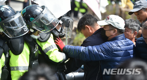 【성주=뉴시스】우종록 기자 = 12일 오전 경북 성주군 초전면 소성리 진밭교에서 경찰이 사드(THAAD·고고도미사일방어체계) 기지의 생활공간 개선을 위한 건설장비·자재 반입을 막으려는 주민과 종교단체 회원들을 강제해산시키고 있다. 2018.04.12.&nbsp; wjr@newsis.com