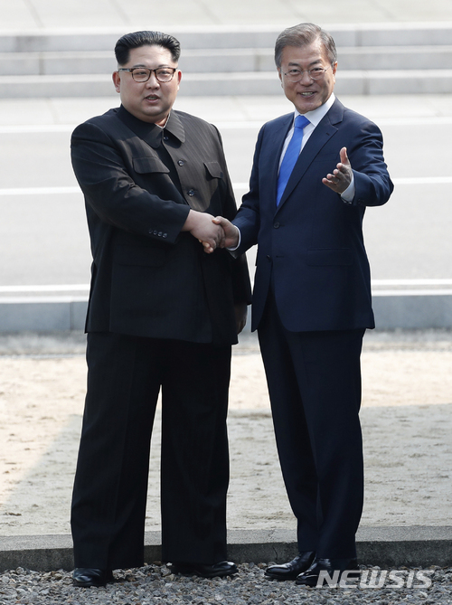 North Korean leader Kim Jong Un, left, shakes hands with South Korean President Moon Jae-in at the border village of Panmunjom in the Demilitarized Zone Friday, April 27, 2018. Kim made history Friday by crossing over the world's most heavily armed border to greet his rival, Moon, for talks on North Korea's nuclear weapons. (Korea Summit Press Pool via AP)