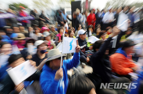 [파주=뉴시스]배훈식 기자 =지난 2018년 4월27일 경기 파주시 임진각에서 시민들이 문재인 대통령과 김정은 북한 국무위원장이 만나 악수하는 장면을 보면서 한반도기를 흔들고 환호하고 있다. 2018.04.27. dahora83@newsis.com