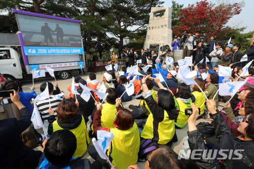 【파주=뉴시스】배훈식 기자 = 2018 남북 정상회담이 열린 27일 오전 경기 파주시 임진각에서 겨레하나 등 시민사회단체 회원들과 시민들이 문재인 대통령과 김정은 북한 노동당위원장이 만나 악수하자 한반도기를 흔들며 환호하고 있다. 2018.04.27. dahora83@newsis.com