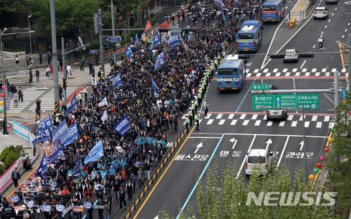 【서울=뉴시스】고범준 기자 = 근로자의 날인 1일 오후 서울 중구 태평로 서울광장에서 열린 2018 세계 노동절 대회를 마친 참석자들이 손 피켓을 들고 행진을 하고 있다. 2018.05.01. bjko@newsis.com