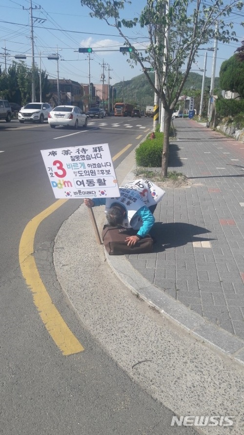 【대구=뉴시스】 강병서 기자 = 경북도의원 경산시2선거구에 출마한 바른미래당 여동활 후보가 4일 오후 경산시 와촌면사무소앞 도로변에서 박근혜 전 대통령 탄핵과 구속, 정치불신을 사죄하는 석고대죄를 하고 있다. 2018.05.07 kbs@newsis.com