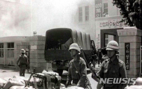 [광주=뉴시스] 1980년 5·18민주화운동 당시 전남도청(현 국립아시아문화전당) 앞에서 군인들이 중무장한 채 경계를 서고 있다. 5·18민주화운동기록관 영상