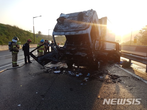 【울산=뉴시스】박일호 기자 = 14일 오전 5시21분께 울산시 북구 신현동 정자에서 무룡터널 방향 도로를 달리던 3.5t 트럭에서 불이 나 신고를 받고 현장에 출동한 소방당국이 피해 규모를 조사하고 있다. 2018.05.14. (사진=울산소방본부 제공) photo@newsis.com