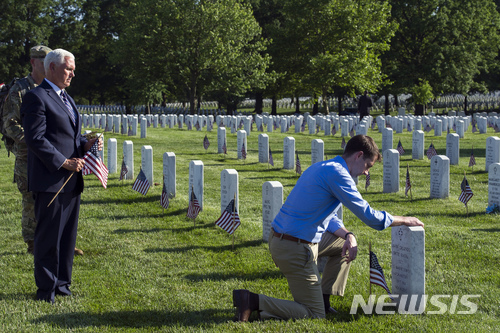 【알링턴 국립묘지 (미 버지니아주) = AP/뉴시스】 마이크 펜스 미국 부통령이 28일 현충일을 맞아 알링턴 국립묘지의 기념식에서 관례에 따라 미 육군 3연대 묘역에 성조기를 헌정하고 있다.