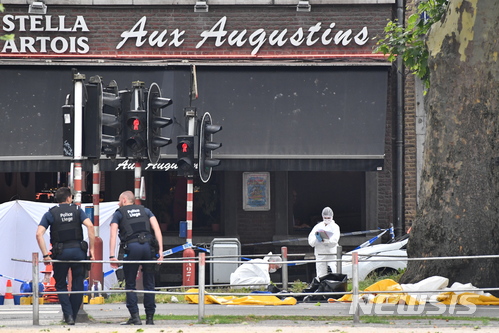 Police investigate at the scene of a shooting in Liege, Belgium, Tuesday, May 29, 2018. A gunman killed three people, including two police officers, in the Belgian city of Liege on Tuesday, a city official said. Police later killed the attacker, and other officers were wounded in the shooting.(AP Photo/Geert Vanden Wijngaert)