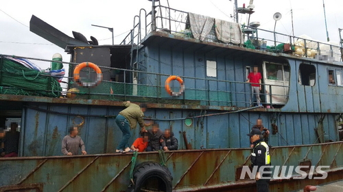 【울산=뉴시스】안정섭 기자 = 11일 오전 부산 기장군 대변외항에서 중국 원양어선 선원들이 복통을 호소하는 선원 A(44)씨를 육지로 이송하고 있다. 2018.06.11. (사진=울산해양경찰서 제공) photo@newsis.com