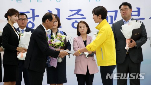 【서울=뉴시스】김선웅 기자 = 15일 서울 종로구 서울특별시선거관리위원회에서 열린 6.13 지방선거 당선증 교부식에서 서울시 비례대표 시의원 정의당 권수정 의원이 당선증을 받고 있다. 2018.06.15. mangusta@newsis.com