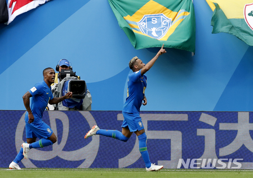 Brazil's Neymar, right, gestures as he celebrates after scoring his team's second goal with teammate Douglas Costa during the group E match between Brazil and Costa Rica at the 2018 soccer World Cup in the St. Petersburg Stadium in St. Petersburg, Russia, Friday, June 22, 2018. (AP Photo/Alastair Grant)