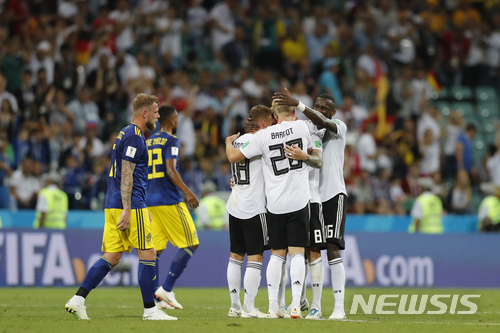 Germany players celebrate their team's 2-1 victory at the of the group F match between Germany and Sweden at the 2018 soccer World Cup in the Fisht Stadium in Sochi, Russia, Saturday, June 23, 2018. (AP Photo/Frank Augstein)