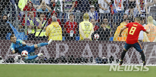 Spain's Koke fails to score by penalty kick during the round of 16 match between Spain and Russia at the 2018 soccer World Cup at the Luzhniki Stadium in Moscow, Russia, Sunday, July 1, 2018. (AP Photo/Antonio Calanni)