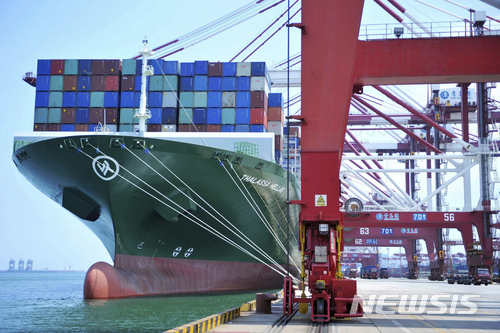 A ship hauls containers at a container port in Qingdao in eastern China's Shandong province Friday, July 6, 2018. The United States hiked tariffs on Chinese imports Friday and Beijing said it immediately retaliated in a dispute between the world's two biggest economies that President Donald Trump says he is prepared to escalate. (Chinatopix via AP)