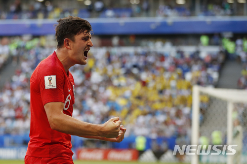 England's Harry Maguire reacts after scoring his side opening goal during the quarterfinal match between Sweden and England at the 2018 soccer World Cup in the Samara Arena, in Samara, Russia, Saturday, July 7, 2018. (AP Photo/Francisco Seco)