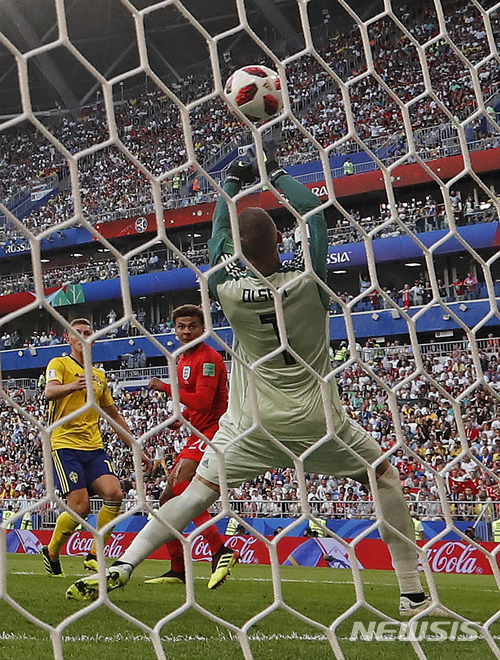 England's Dele Alli, center, scores his side's second goal during the quarterfinal match between Sweden and England at the 2018 soccer World Cup in the Samara Arena, in Samara, Russia, Saturday, July 7, 2018. (AP Photo/Frank Augstein) 