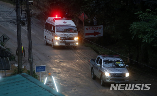 One of two ambulances leave the cave in northern Thailand hours after operation began to rescue the trapped youth soccer players and their coach, in Mae Sai, Chiang Rai province, in northern Thailand, Sunday, July 8, 2018. Chiang Rai province acting Gov. Narongsak Osatanakorn, who is heading the operation, said earlier Sunday that 13 foreign and five Thai divers were taking part in the rescue and two divers will accompany each boy as they're gradually extracted. He said the operation began at 10 a.m., and it will take at least 11 hours for the first person to be taken out of the cave. (AP Photo/Sakchai Lalit)