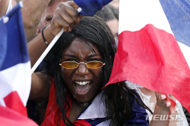 A French soccer team supporter shouts on the Champ de Mars as she watches the World Cup final between France and Croatia, Sunday, July 15, 2018 in Paris. (AP Photo/Laurent Cipriani)