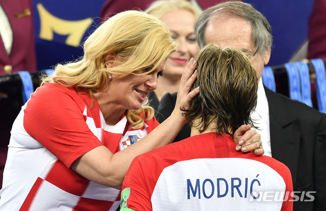 Croatian President Kolinda Grabar-Kitarovic hugs Croatia's Luka Modric after France won the final match between France and Croatia at the 2018 soccer World Cup in the Luzhniki Stadium in Moscow, Russia, Sunday, July 15, 2018. (AP Photo/Martin Meissner)