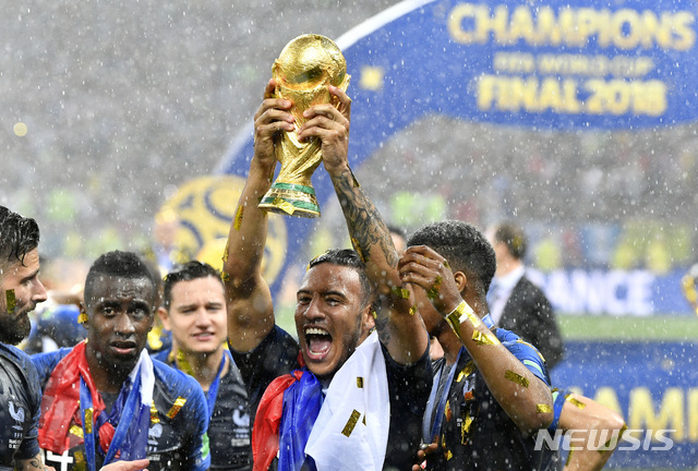 France's Corentin Tolisso celebrates with the trophy after France won 4-2 during the final match between France and Croatia at the 2018 soccer World Cup in the Luzhniki Stadium in Moscow, Russia, Sunday, July 15, 2018. (AP Photo/Martin Meissner)