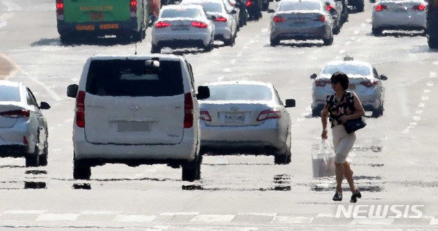 【서울=뉴시스】고범준 기자 = 서울 기온이 39.4도까지 오르며 기상 관측 111년 만에 최고 기온을 기록한 1일 오후 서울 영등포구 여의도동 인근 도로에 지열로 인해 아지랑이가 피어 오르고 있다. 2018.08.01.&nbsp; bjko@newsis.com