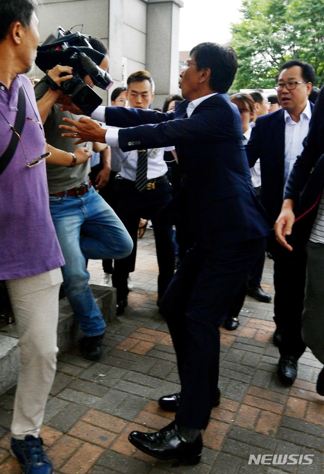 【서울=뉴시스】 조성봉 기자 = 비서를 성폭행한 혐의로 기소된 안희정 전 충남도지사(오른쪽)가 14일 오전 서울 마포구 서울서부지방법원에서 열린 1심 선고를 마치고 법정을 나서던 중 넘어지는 취재진을 잡아주고 있다. 2018.08.14. photo@newsis.com