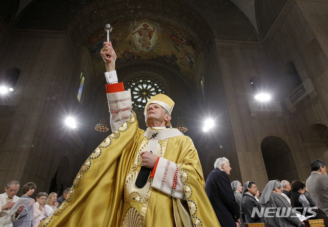 【워싱턴=AP/뉴시스】양소리 기자 = 미국 워싱턴 대주교인 도널드 우얼 추기경이 2011년 워싱턴의 한 교회에서 성수를 뿌리고 있다. 우얼 추기경은 펜실베이니아주 가톨릭 교구 성직자들의 아동 성학대 사건을 은폐했다는 의혹을 받고 있다. CNN은 2일(현지시간) 우얼 추기경이 강론하는 동안 일부 신자가 "부끄러운 줄 알라"며 고함을 치고 자리를 떴다고 보도했다. 2018.09.03