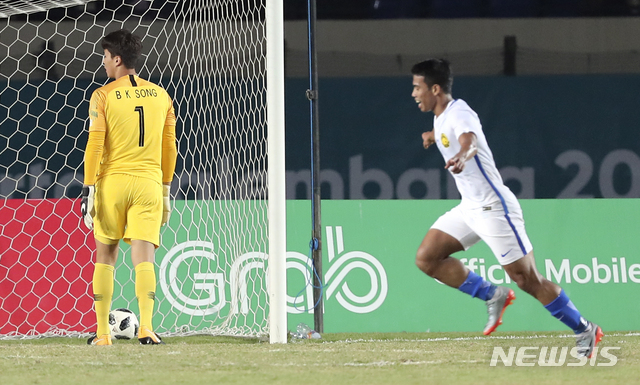 【반둥(인도네시아)=뉴시스】최진석 기자 = 17일(현지시각) 인도네시아 반둥 시 잘락 하루팟 스타디움에서 열린 2018 자카르타·팔렘방 아시안게임 남자 축구 조별리그 E조 2차전 대한민국과 말레이시아의 경기. 말레이시아 라시드가 골을 넣은 뒤 기뻐하자 송범근이 아쉬워하고 있다. 2018.08.17. myjs@newsis.com