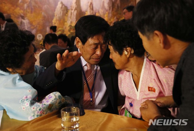 【금강산=뉴시스】뉴스통신취재단 = 제21차 이산가족 상봉행사 1회차 첫날인 20일 오후 금강산호텔에서 열린 단체상봉에서 남측 김춘식(80) 할아버지가 북측의 동생들 김춘실(77·오른쪽)과 김춘녀(71)를 만나고 있다. 2년 10개월 만에 열리는 이산가족 상봉은 20일부터 26일까지 금강산에서 진행된다. 2018.08.20. photo@newsis.com
