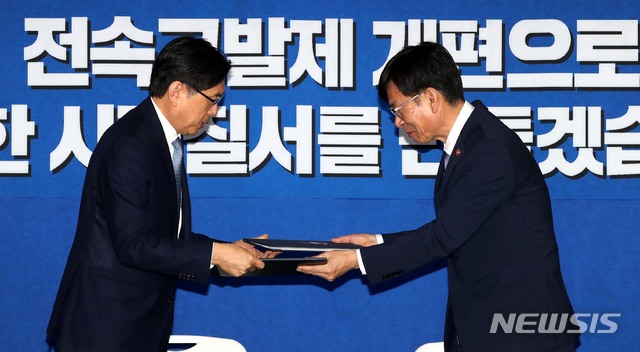 【서울=뉴시스】고범준 기자 = 박상기 법무부 장관과 김상조 공정거래위원장이 21일 오전 서울 종로구 세종대로 정부서울청사 브리핑룸에서 공정거래법 전속고발제 개편 합의문 서명식을 마친 뒤 합의문을 교환하고 있다. 2018.08.21.&nbsp; bjko@newsis.com