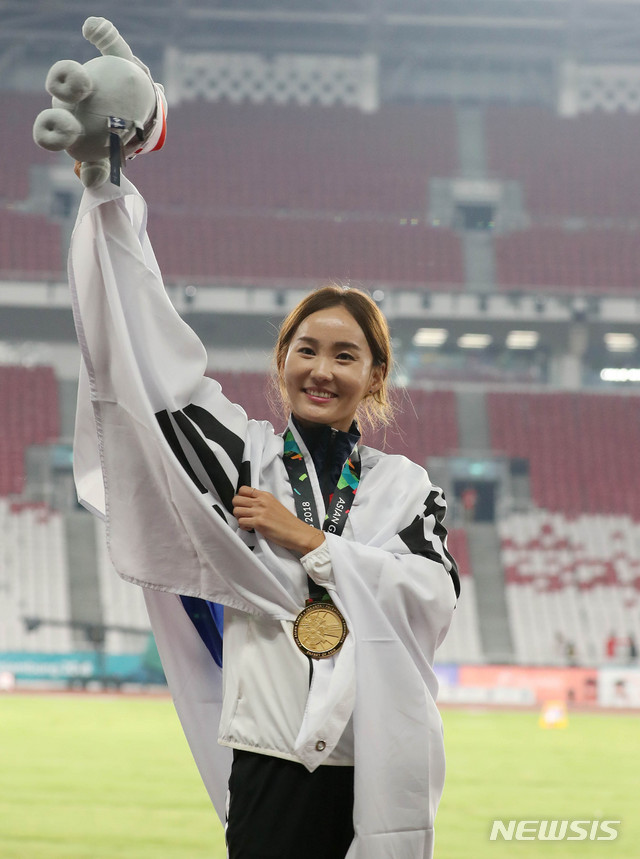 【자카르타(인도네시아)=뉴시스】추상철 기자 = 2018 자카르타-팔렘방 아시안게임 육상 여자 100m 허들 시상식이 열린 26일(현지시각) 오후 인도네시아 자카르타 겔로라 붕 카르노(GBK) 메인 스타디움에서 대한민국 정혜림이 금메달을 목에 걸고 마스코트를 올려 보이고 있다. 2018.08.26. scchoo@newsis.com