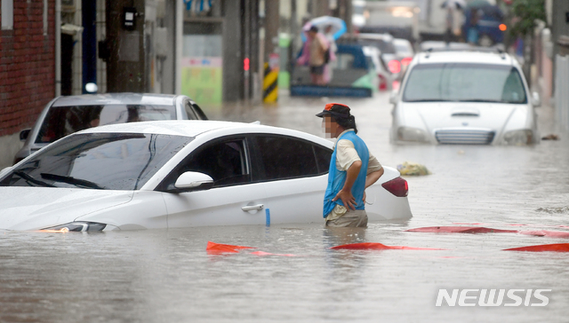 【광주=뉴시스】류형근 기자 = 호우특보가 내려진 31일 오전 광주 남구 주월동 주택가 골목길이 폭우에 침수된 가운데 한 주민이 물에 잠겨버린 차량을 바라보고 있다. 이지역은 지난 27일에도 폭우에 침수돼 많은 피해를 입었다. 2018.08.31.&nbsp; hgryu77@newsis.com