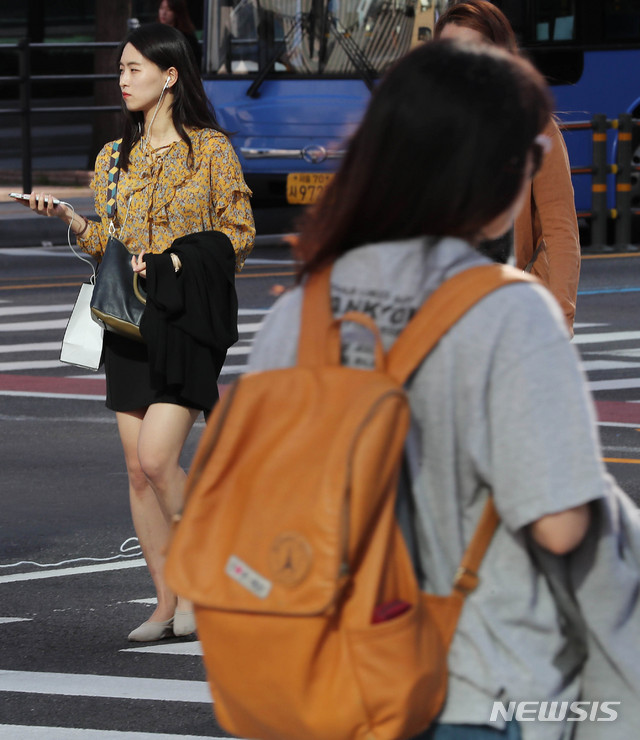 【서울=뉴시스】최진석 기자 = 일교차가 10도 이상 크게 벌어질것으로 예보된 10일 오전 서울 광화문 네거리에서 시민이 외투를 손에 들고 출근길 발걸음을 재촉하고 있다. 2018.09.10. myjs@newsis.com