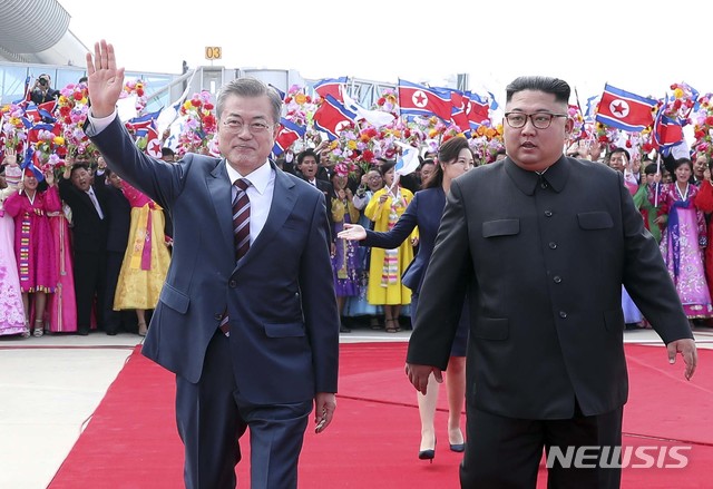 【평양=뉴시스】평양사진공동취재단 박진희 기자 = 문재인 대통령과 김정은 국무위원장이 18일 오전 평양 순안공항에서 열린 공식 환영식에서 평양 시민들의 환영을 받으며 이동하고 있다. 2018.09.18. photo@newsis.com