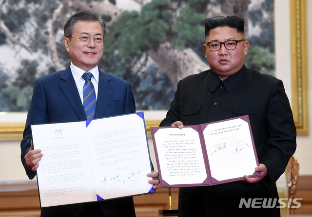 【평양=뉴시스】평양사진공동취재단 박진희 기자 = 문재인 대통령과 김정은 국무위원장이 19일 오전 평양 백화원 영빈관에서 평양공동선언문에 서명한 후 합의서를 들어보이고 있다. 2018.09.19.photo@newsis.com