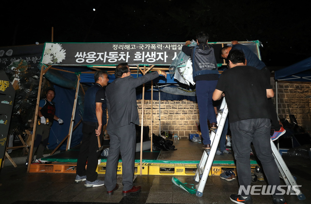 【서울=뉴시스】조성봉 기자 = 김득중 금속노조 쌍용자동차지부장을 비롯한 관계자들이 19일 오후 서울 중구 덕수궁 대한문 앞 쌍용차 해고자·가족 희생자 분향소에서 열린 마지막 문화제 '당신과 함께여서 행복합니다'를 마치고 분향소를 철거하고 있다. 2018.09.19. suncho21@newsis.com 