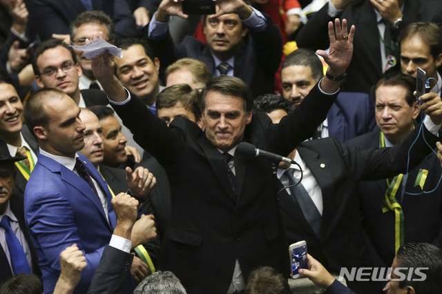 【브라질리아=AP/뉴시스】브라질에서 7일 대통령선거가 치러진다. 사진은 지지율 1위의 자이르 보우소나루 후보가 지난 2017년 4월 18일 브라질리아 국회의사당에서 지우마 호세프 당시 대통령의 탄핵 찬성 의사를 나타낸 후 양팔을 들어올려 환호하는 보우소나루의 모습. 2018.10.07