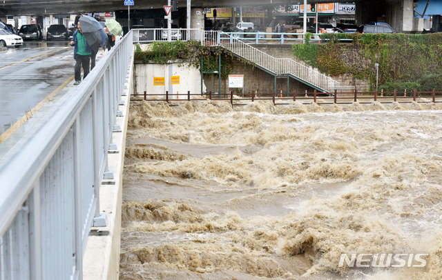 【대구=뉴시스】우종록 기자 = 태풍 '콩레이'의 영향으로 많은 비가 내린 6일 오전 대구 북구 칠성동 1가 신성교 아래로 흙탕물이 거세게 흘러내리고 있다. 2018.10.06. wjr@newsis.com