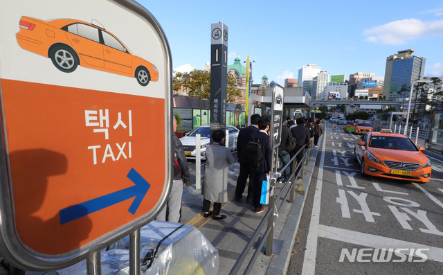 【서울=뉴시스】배훈식 기자 = 카카오의 카풀 서비스에 반발해 택시업계가 파업에 돌입한 18일 오전 서울 용산구 서울역 앞 택시승강장에 시민들이 길게 줄을 서고 있다. 2018.10.18. dahora83@newsis.com